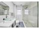 Modern bathroom featuring a glass enclosed shower, mosaic tile and stylish vanity at 150 23Rd N Ave, St Petersburg, FL 33704
