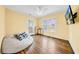 Bright bedroom with hardwood floors, a ceiling fan, and plenty of natural light from the windows and door at 150 23Rd N Ave, St Petersburg, FL 33704