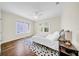 Sunlit bedroom boasts hardwood floors, windows, and a patterned rug, creating a welcoming space at 150 23Rd N Ave, St Petersburg, FL 33704