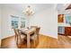 Bright dining area featuring hardwood floors and a modern chandelier, perfect for Gathering meals at 150 23Rd N Ave, St Petersburg, FL 33704