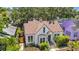 Charming white home with a brown roof, surrounded by lush landscaping and mature trees at 150 23Rd N Ave, St Petersburg, FL 33704