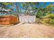 Exterior view of a detached two-car garage with a gravel driveway and a wooden fence at 150 23Rd N Ave, St Petersburg, FL 33704