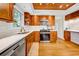Modern kitchen featuring stainless steel appliances, white countertops, and wood floors at 150 23Rd N Ave, St Petersburg, FL 33704