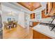 Open kitchen and dining area featuring hardwood floors, stainless appliances, and a modern chandelier at 150 23Rd N Ave, St Petersburg, FL 33704