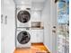 Convenient laundry room with stacked washer and dryer, storage cabinets, and easy access to outdoor space at 150 23Rd N Ave, St Petersburg, FL 33704