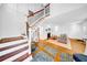 Open-concept living space with hardwood floors, staircase and fireplace at 150 23Rd N Ave, St Petersburg, FL 33704