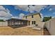 Spacious backyard features a screened-in patio and partial fencing, perfect for outdoor living and entertaining at 15411 Quail Woods Pl, Ruskin, FL 33573
