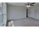 Bright bedroom with carpeted floors, ceiling fan, closet, and plenty of natural light at 15411 Quail Woods Pl, Ruskin, FL 33573