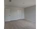 Carpeted bedroom with large closet, white doors, and a light fixture at 15411 Quail Woods Pl, Ruskin, FL 33573
