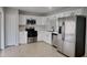 Modern kitchen featuring stainless steel appliances and white cabinets at 15411 Quail Woods Pl, Ruskin, FL 33573