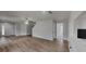 Bright living room with new wood floors and modern ceiling fan at 15411 Quail Woods Pl, Ruskin, FL 33573