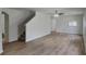 Spacious living room featuring beautiful floors and a staircase at 15411 Quail Woods Pl, Ruskin, FL 33573