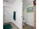 Clean bathroom featuring tile floors, white walls, modern fixtures, and an adjacent water closet at 17228 Holly Well Ave, Wimauma, FL 33598