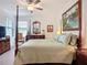 Comfortable bedroom with ceiling fan, beautiful furniture, artwork, and natural light coming through the window at 17228 Holly Well Ave, Wimauma, FL 33598