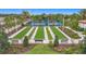 Bocce ball courts are surrounded by meticulously maintained landscaping and benches for spectators at 17228 Holly Well Ave, Wimauma, FL 33598