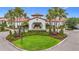Stunning clubhouse entrance featuring arched entryway and lush landscaping at 17228 Holly Well Ave, Wimauma, FL 33598
