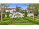 Medley Clubhouse entry showcasing manicured landscaping and a beautiful building at 17228 Holly Well Ave, Wimauma, FL 33598