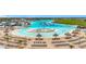 An aerial view of the lagoon featuring white sand beaches, clear water, and chairs for residents at 17228 Holly Well Ave, Wimauma, FL 33598