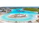 The lagoon features clear water and a sandy beach island with beach chairs for a relaxing day in the sun at 17228 Holly Well Ave, Wimauma, FL 33598