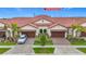Beautiful new home showcases lush landscaping, tile roof, and attached garages at 17228 Holly Well Ave, Wimauma, FL 33598