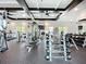 Bright, well-equipped gym with weights, machines, and natural lighting at 17228 Holly Well Ave, Wimauma, FL 33598
