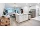 Open kitchen featuring a spacious island, modern stainless steel appliances, and a combined dining and living area at 17228 Holly Well Ave, Wimauma, FL 33598