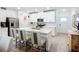 Modern kitchen featuring an island with bar stool seating, stainless appliances, and white cabinetry at 17228 Holly Well Ave, Wimauma, FL 33598