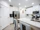 Kitchen featuring an island with seating and stainless steel appliances at 17228 Holly Well Ave, Wimauma, FL 33598