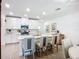 Bright kitchen with white cabinets, stainless steel appliances, and a center island with seating at 17228 Holly Well Ave, Wimauma, FL 33598