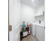 Compact laundry room with washer, dryer and tile flooring at 17228 Holly Well Ave, Wimauma, FL 33598
