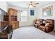 Comfortable living room showcases plush seating, ceiling fan, and natural light at 17228 Holly Well Ave, Wimauma, FL 33598