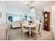 Spacious living room and dining area with stylish furniture, elegant lighting, and hardwood floors at 17228 Holly Well Ave, Wimauma, FL 33598