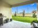 Cozy covered patio with BBQ grill, view of the backyard and fence at 17228 Holly Well Ave, Wimauma, FL 33598