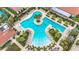 An aerial view of a community pool with many lounge chairs and tropical landscaping at 17228 Holly Well Ave, Wimauma, FL 33598