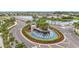 Impressive water feature at the entrance of the community, with many palm trees and flowers at 17228 Holly Well Ave, Wimauma, FL 33598