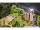 Aerial view showcases a house with a private dock and lakeside patio at 17301 Estes Rd, Lutz, FL 33548