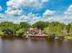 Waterfront home with private dock, serene lake views, and lush landscaping creating a peaceful oasis at 17301 Estes Rd, Lutz, FL 33548