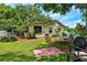 A serene backyard with lush greenery and outdoor seating, perfect for relaxation and entertaining at 17301 Estes Rd, Lutz, FL 33548