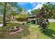 Inviting backyard features a gazebo, fire pit, and lush green lawn with lake access at 17301 Estes Rd, Lutz, FL 33548