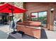Backyard deck features a hot tub and outdoor seating under an umbrella by a stone chimney at 17301 Estes Rd, Lutz, FL 33548
