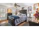 Comfortable bedroom with hardwood floors, a ceiling fan, and lots of natural light at 17301 Estes Rd, Lutz, FL 33548