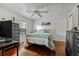 Comfortable bedroom featuring wood floors, a ceiling fan, and dresser with warm and inviting decor at 17301 Estes Rd, Lutz, FL 33548