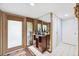 A home entrance featuring a small wine rack, a frosted glass door, and tiled floors at 17301 Estes Rd, Lutz, FL 33548