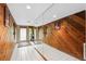 Home entrance with tile flooring, a large mirror, and wood-paneled walls at 17301 Estes Rd, Lutz, FL 33548
