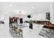 Open kitchen featuring black and stainless appliances, marble countertops, white cabinetry, and bar seating at 17301 Estes Rd, Lutz, FL 33548