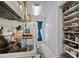 Functional kitchen with white appliances, open shelving, and an exterior door with natural lighting at 17301 Estes Rd, Lutz, FL 33548