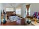 Cozy living room with hardwood floors, neutral-colored sofa, a ceiling fan, and a view to the outside at 17301 Estes Rd, Lutz, FL 33548