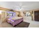 Spacious main bedroom featuring a patterned bedspread, ample closet space, and neutral decor at 17301 Estes Rd, Lutz, FL 33548