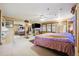 Spacious main bedroom featuring a patterned bedspread, ample closet space, and neutral decor at 17301 Estes Rd, Lutz, FL 33548