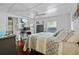 Inviting bedroom with wood floors, a ceiling fan, and a charming view to the outside at 17301 Estes Rd, Lutz, FL 33548